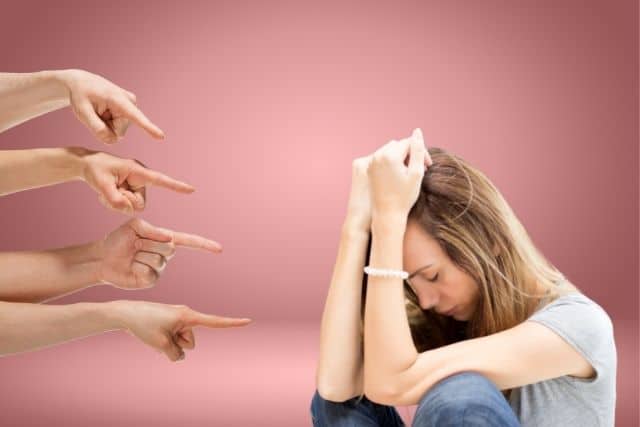 four shaming hands pointing at mom feeling guilty